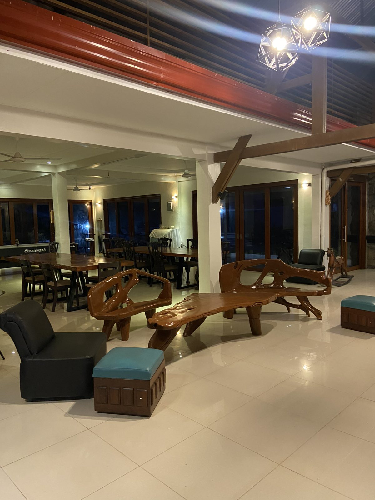 Spacious dining and common area with rustic wooden furniture and modern lighting